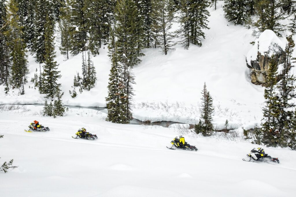 Ski Doo snowmobiles on trail