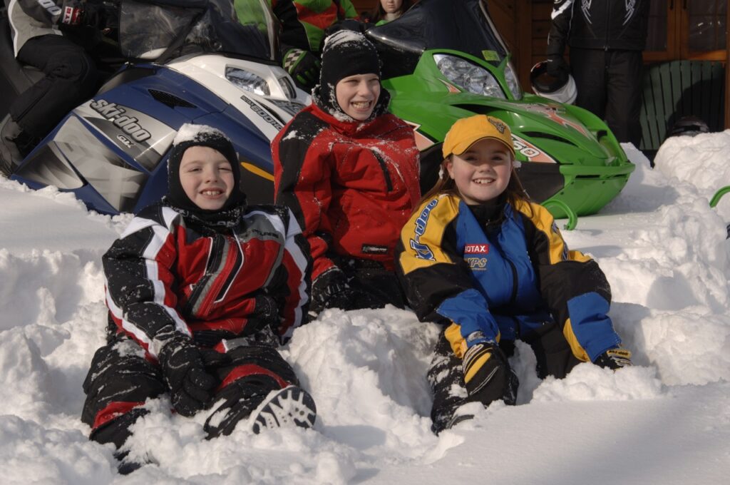 snowmobiling with kids in the snow