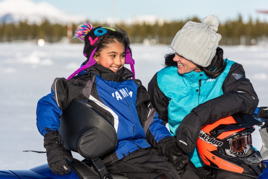 Mom and child on snowmobile