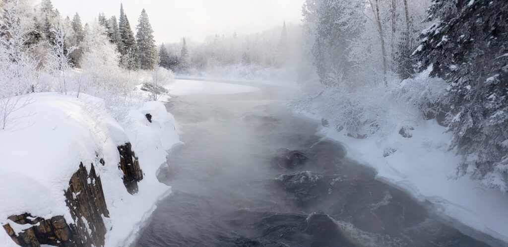 Snowmobile Greater Sudbury Region to see sights and scenery like this misty river.