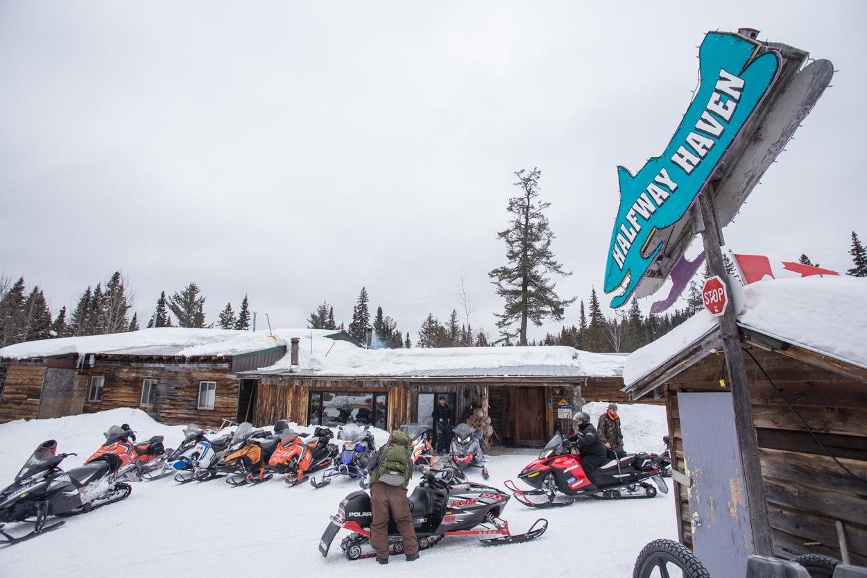 Snowmobilers stopping at a remote snowmobile outpost.
