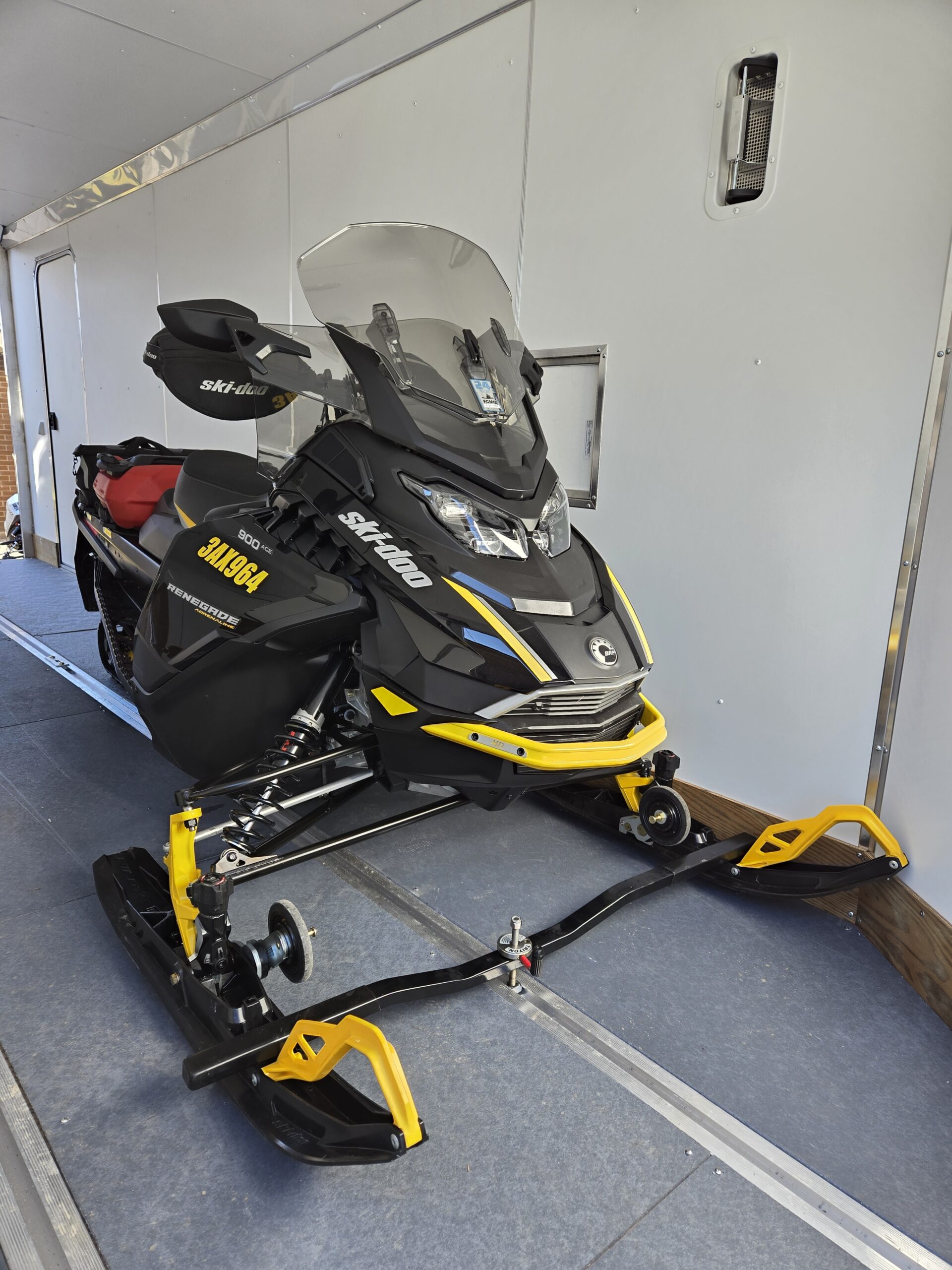 Note that wheels should be disengaged after sled is positioned in trailer and before ski bar is clamped down.